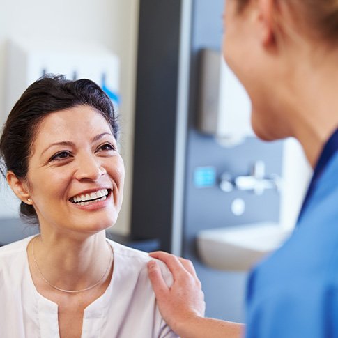 Patient in San Antonio talking to dentist about dental implants