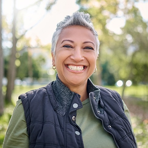 Senior woman standing outside and smiling