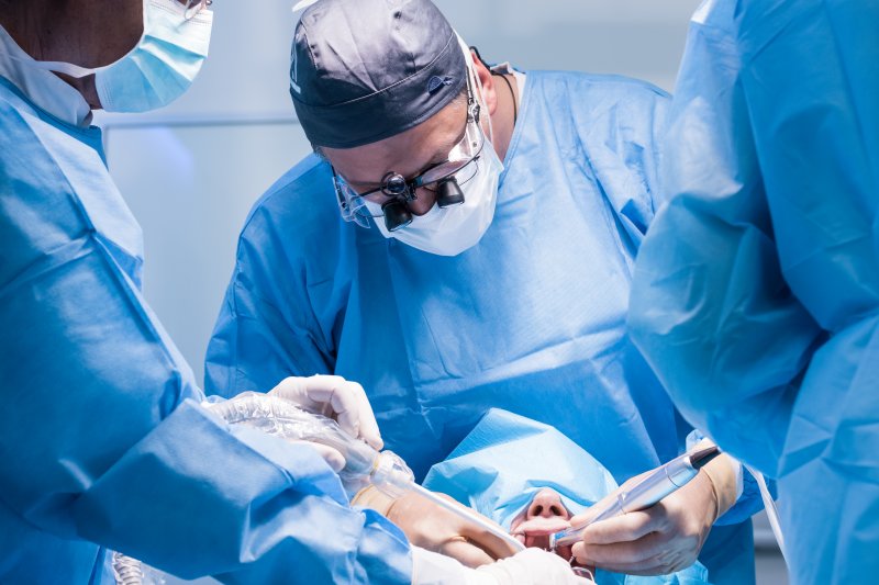 Dentists performing a dental implant surgery