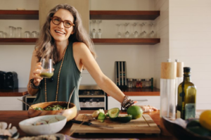 Woman smiling with a smoothie in her kitchen